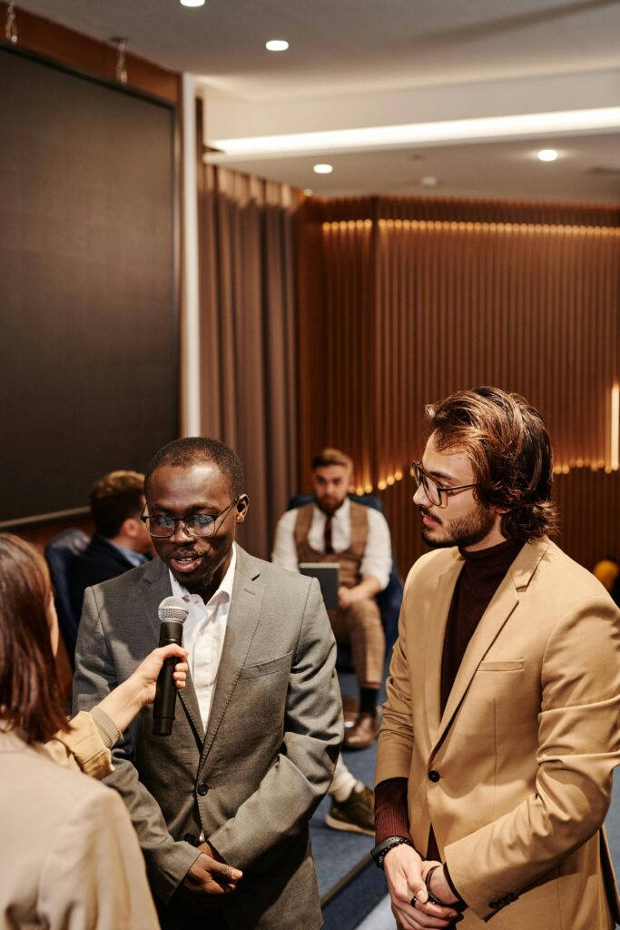 Business professionals engaged in an interview setting indoors, showcasing corporate attire and communication.